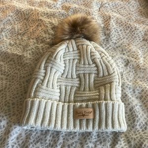 Knitted hat with fuzzy ball